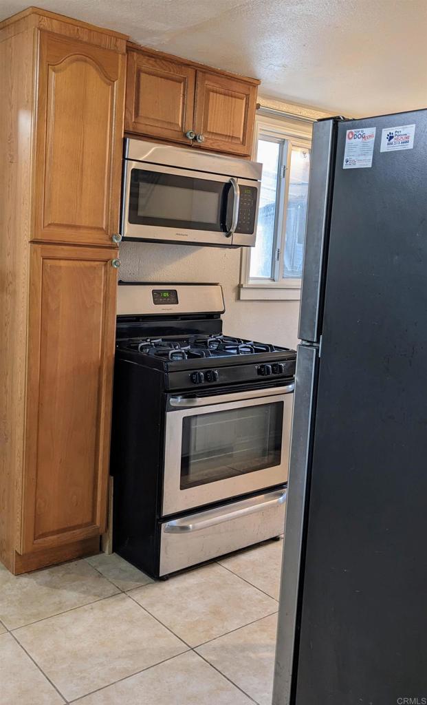 3258 Tyler Street Carlsbad, CA 92008 - Photo 4 of 27 a kitchen with granite countertop cabinets and steel stainless steel appliances