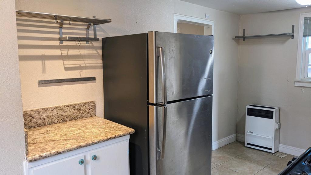 3258 Tyler Street Carlsbad, CA 92008 - Photo 5 of 27 a kitchen with metallic refrigerator freezer and a dishwasher