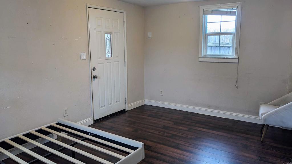3258 Tyler Street Carlsbad, CA 92008 - Photo 10 of 27 an empty room with wooden floor cabinet and windows