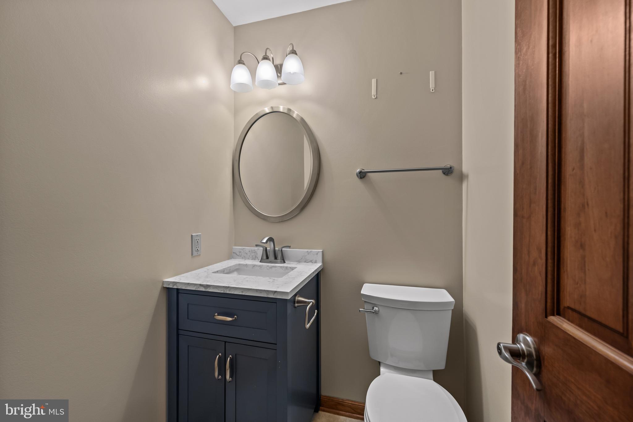 5313 Wentz Road Manchester, MD 21102 - Photo 28 of 51 a bathroom with a toilet a sink and mirror