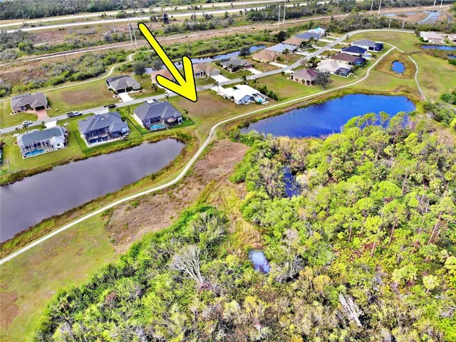 a view of a balcony with chairs and umbrella