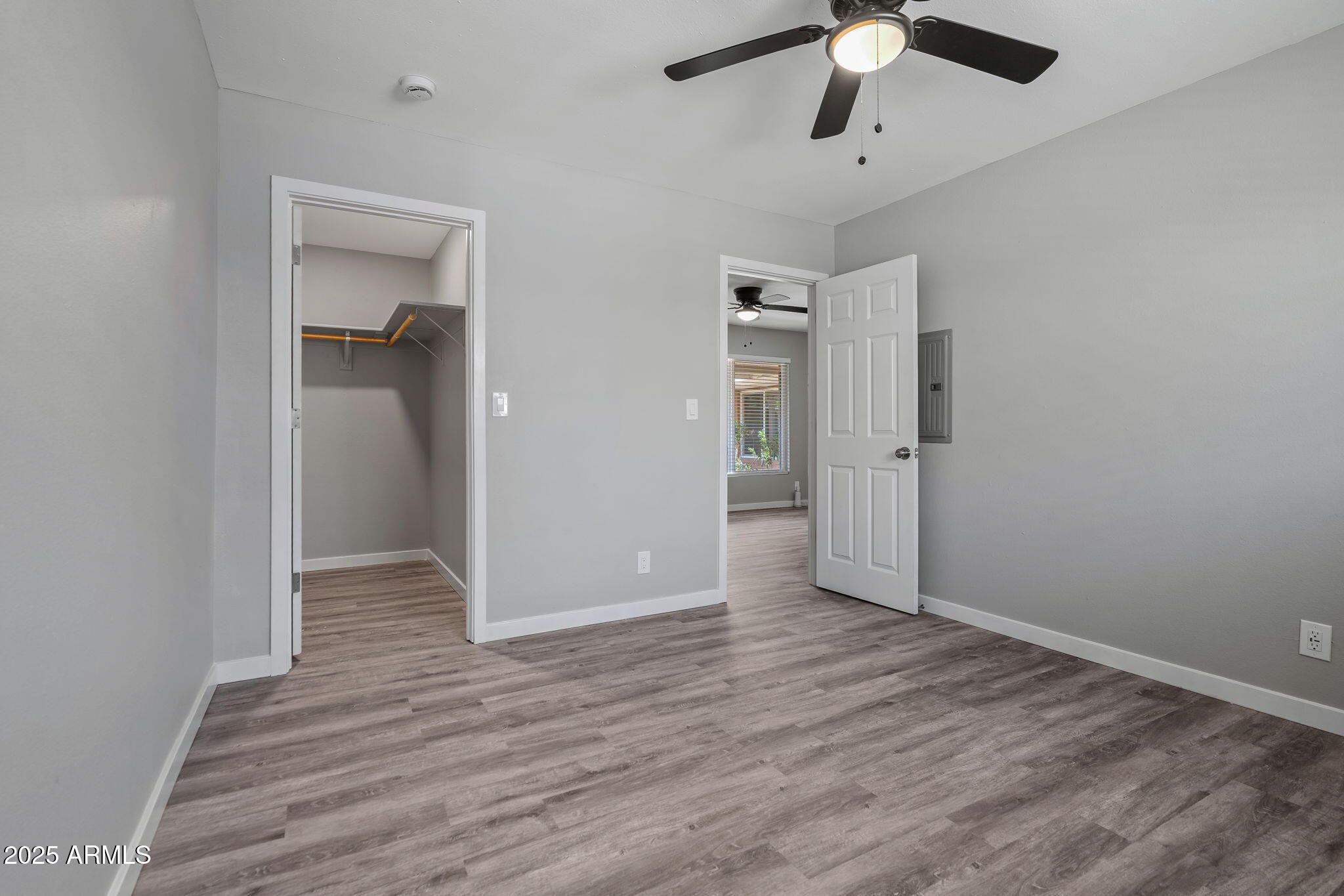 1940 West Amelia Avenue, Unit 1940 5 Phoenix, AZ 85015 - Photo 12 of 14 an empty room with wooden floor cabinet and a ceiling fan