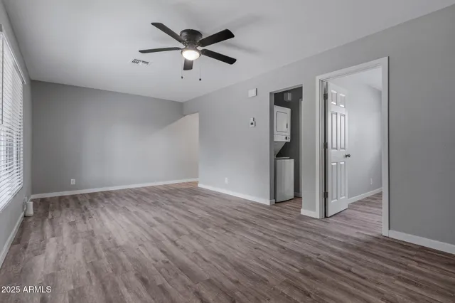an empty room with wooden floor and a window