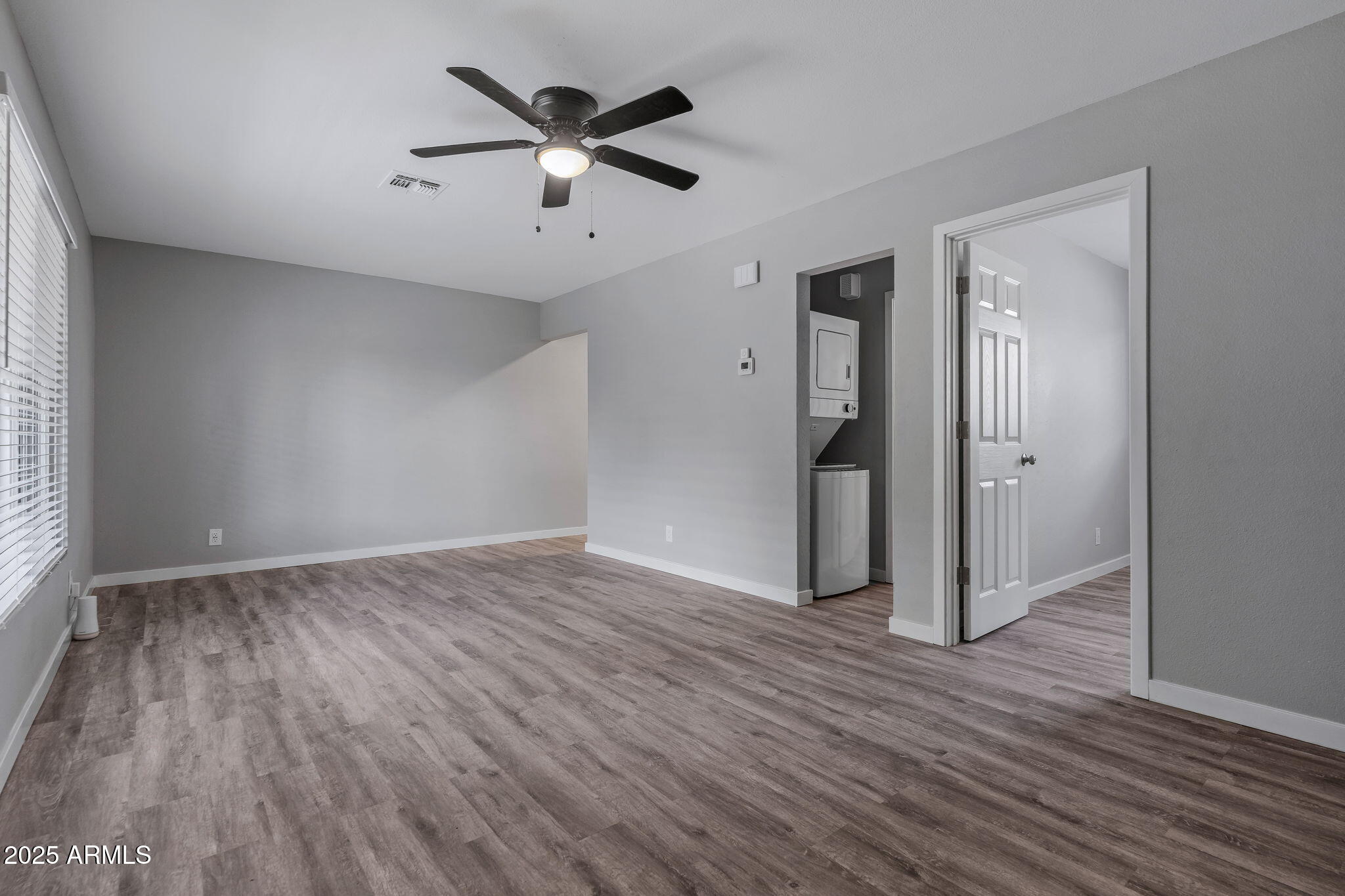1940 West Amelia Avenue, Unit 1940 5 Phoenix, AZ 85015 - Photo 4 of 14 an empty room with wooden floor and a window