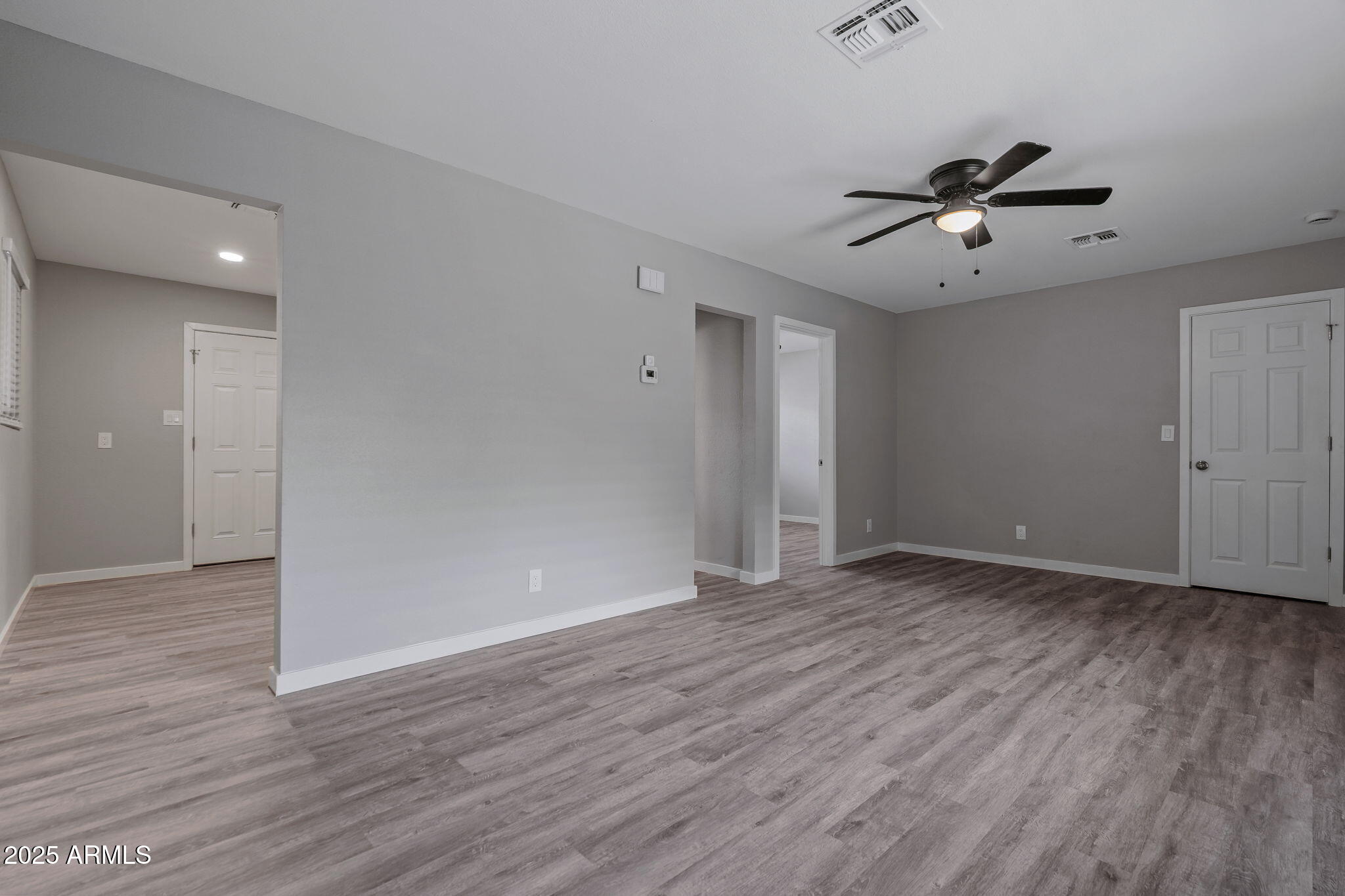 1940 West Amelia Avenue, Unit 1940 5 Phoenix, AZ 85015 - Photo 5 of 14 wooden floor in an empty room with a window