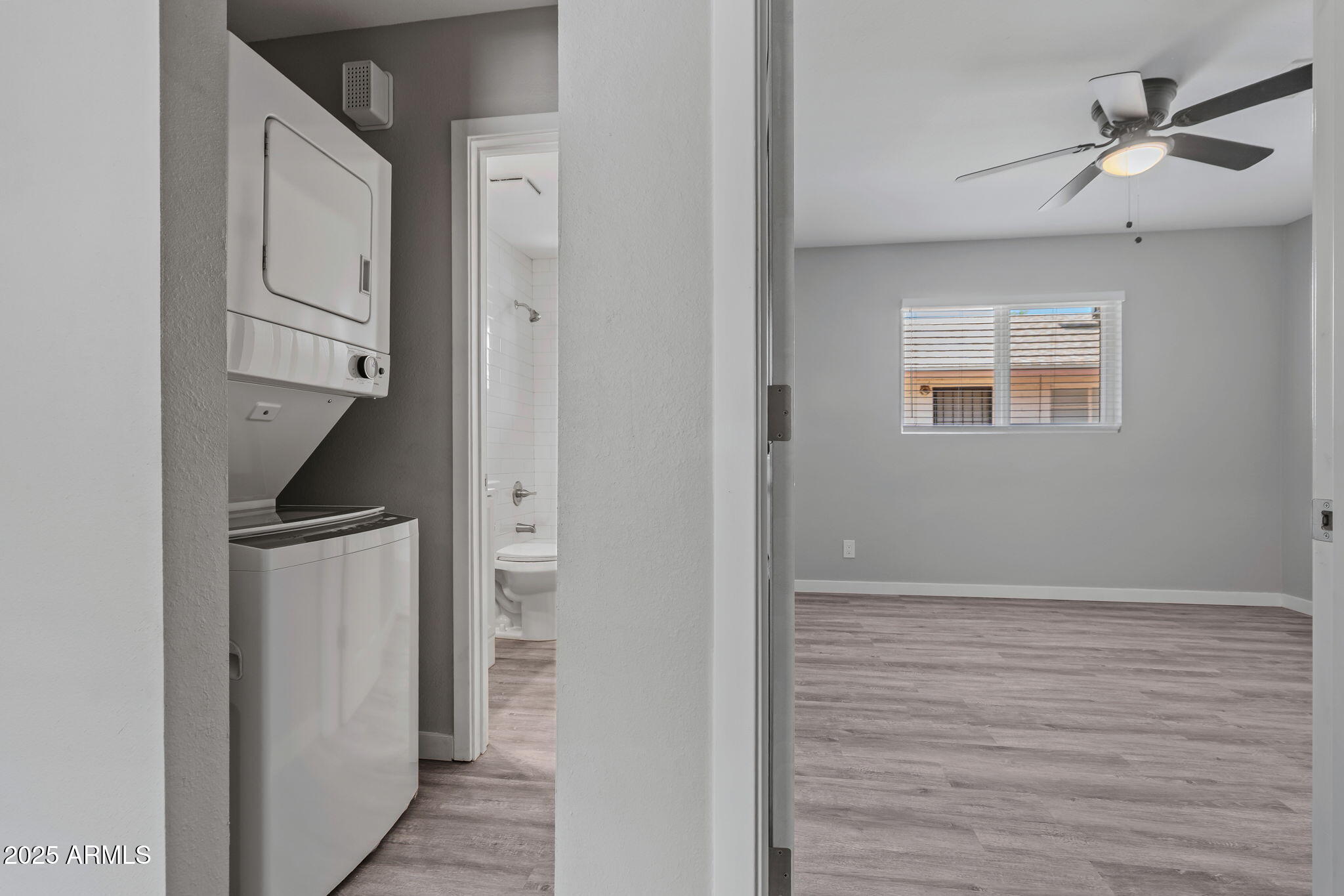 1940 West Amelia Avenue, Unit 1940 5 Phoenix, AZ 85015 - Photo 6 of 14 a view of an empty room with closet and a ceiling fan