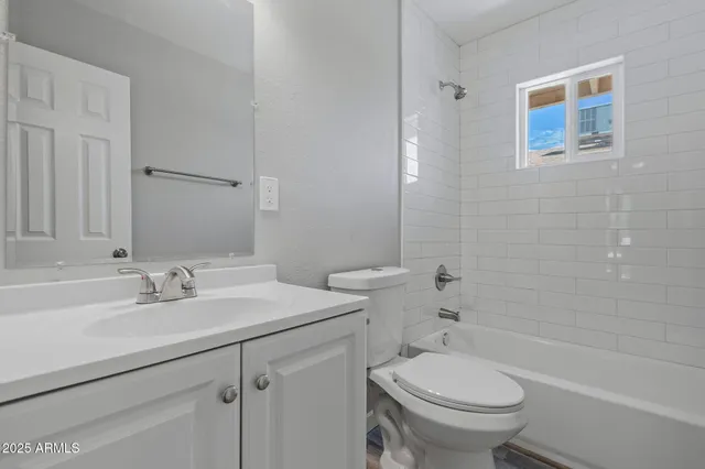 a bathroom with a sink toilet vanity and shower
