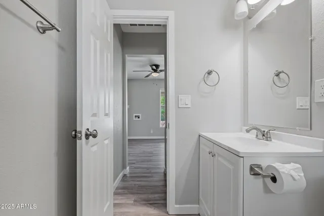 a bathroom with a shower sink and mirror
