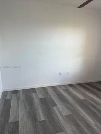 a view of an empty room and wooden floor