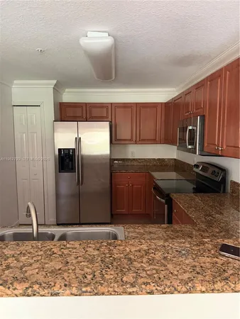 a kitchen with a refrigerator and a sink
