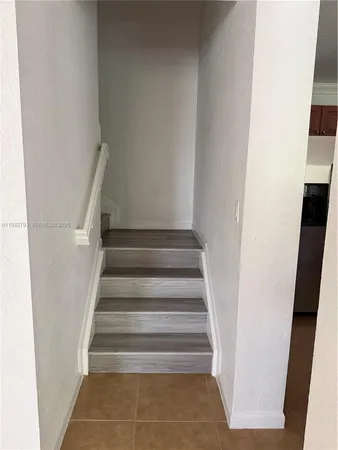 a view of staircase with white walls and a window