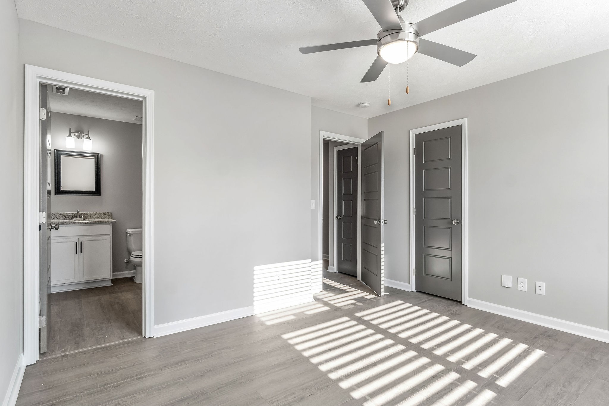 303 Longshadow Trail, Unit E Clarksville, TN 37043 - Photo 13 of 29 a bedroom with a bed and a chandelier