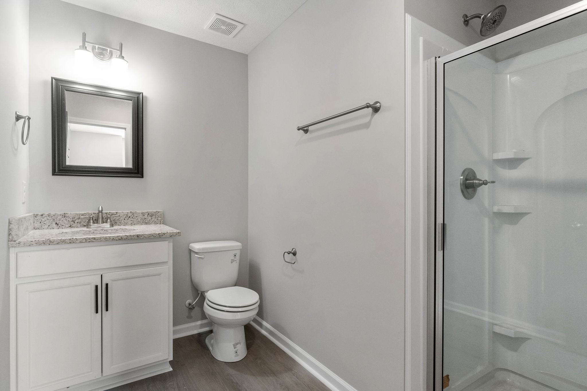 303 Longshadow Trail, Unit E Clarksville, TN 37043 - Photo 14 of 29 a bathroom with a granite countertop toilet a sink and a mirror