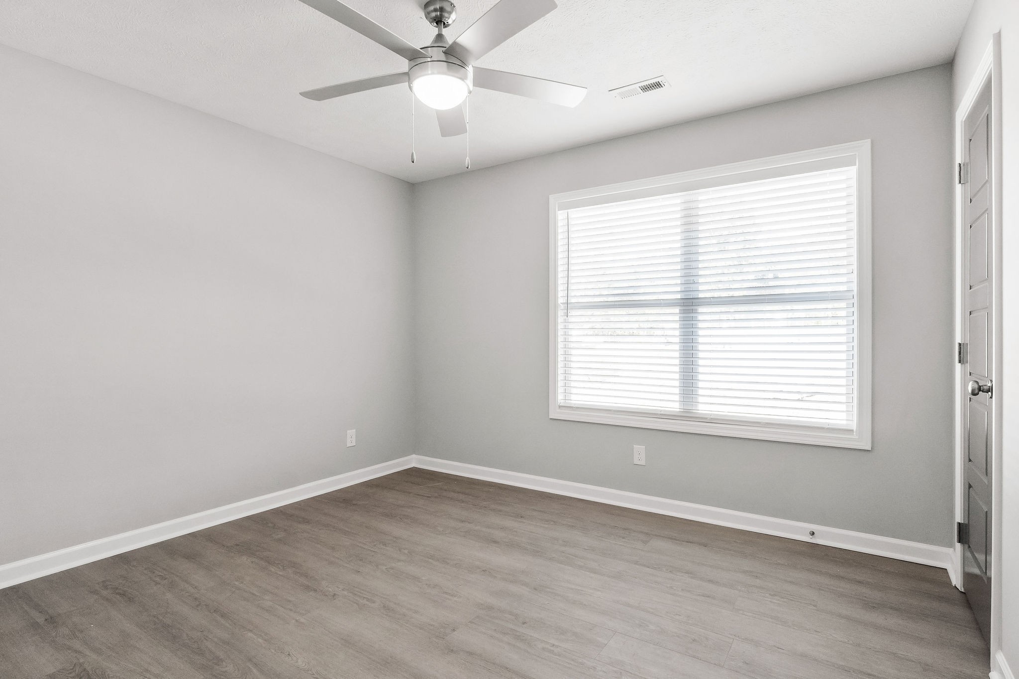 303 Longshadow Trail, Unit E Clarksville, TN 37043 - Photo 17 of 29 wooden floor in an empty room with a window