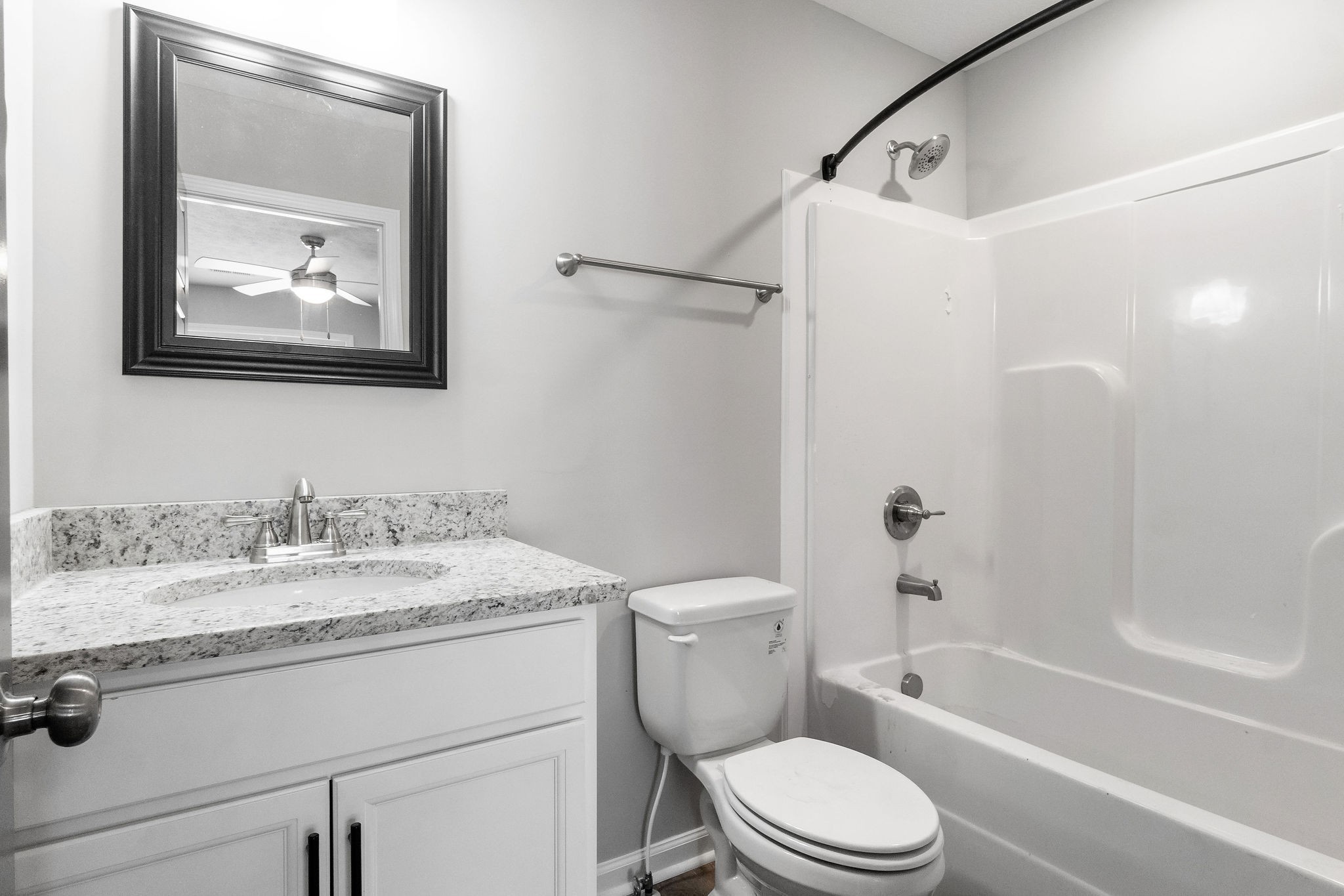 303 Longshadow Trail, Unit E Clarksville, TN 37043 - Photo 19 of 29 a bathroom with a granite countertop toilet a sink and a bathtub