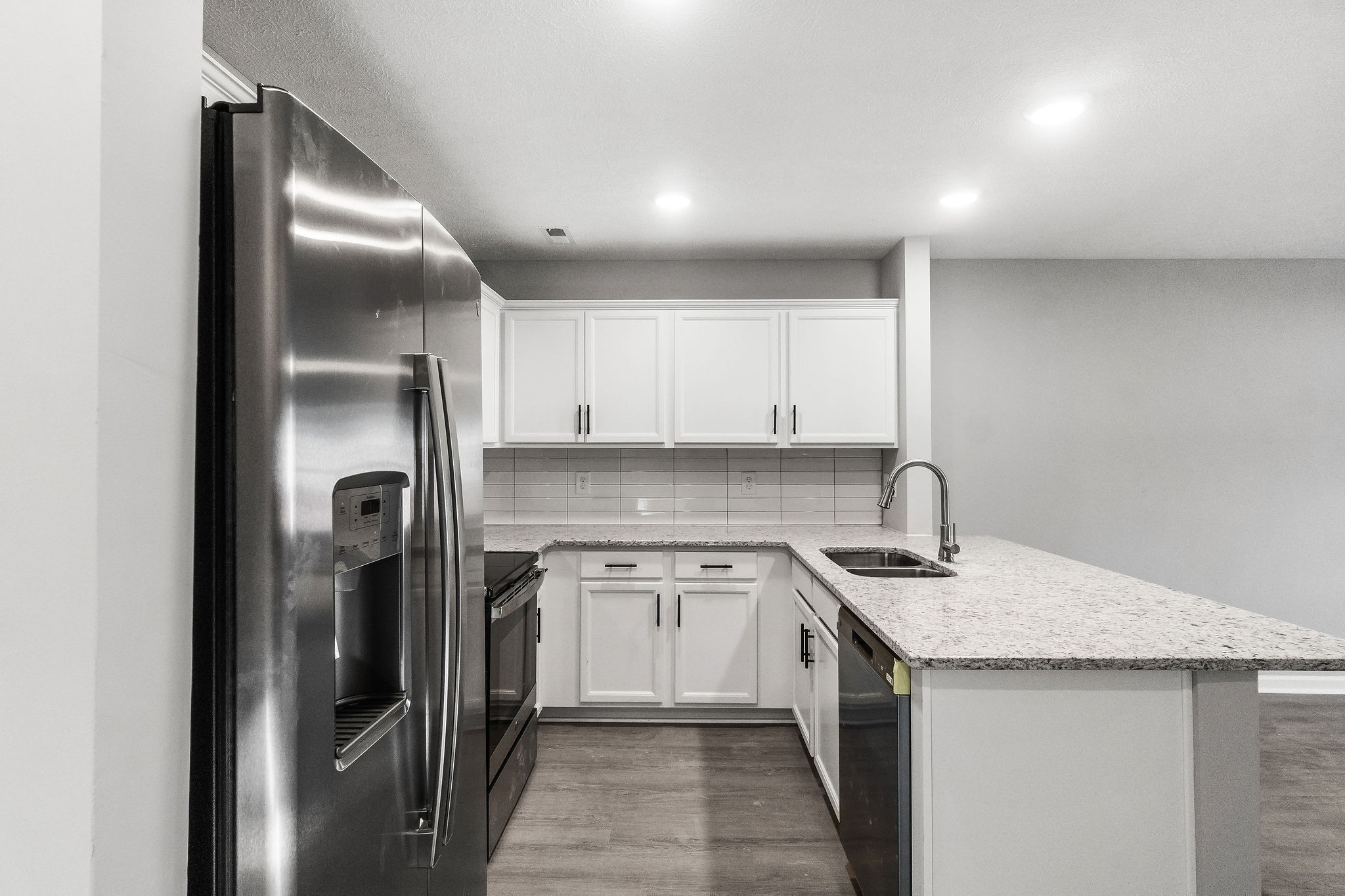 303 Longshadow Trail, Unit E Clarksville, TN 37043 - Photo 3 of 29 a kitchen with stainless steel appliances granite countertop a sink a refrigerator and a stove