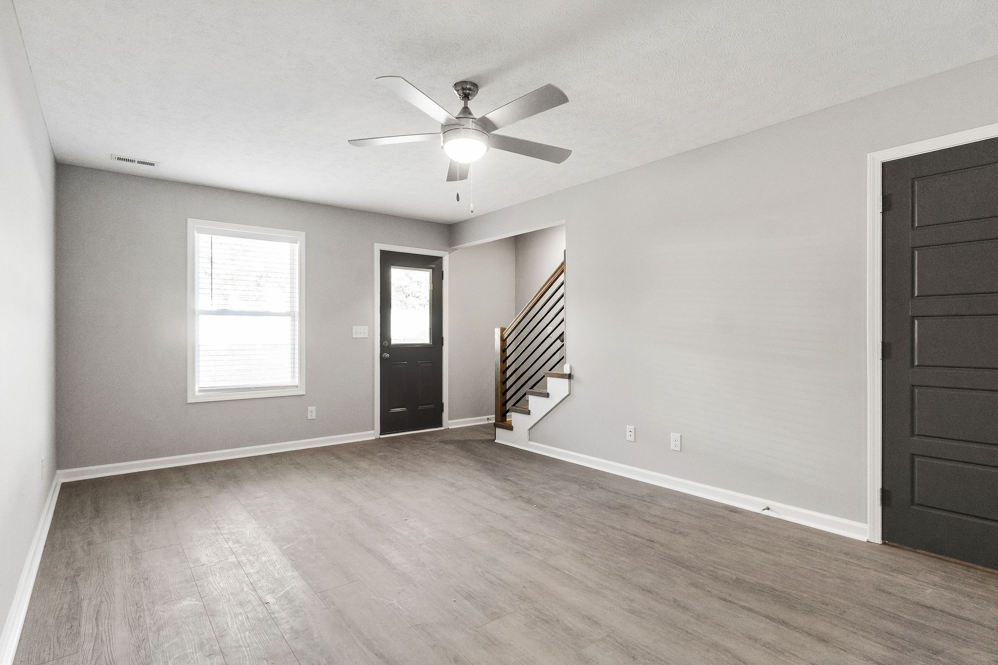 303 Longshadow Trail, Unit E Clarksville, TN 37043 - Photo 9 of 29 a view of an empty room with wooden floor and a window