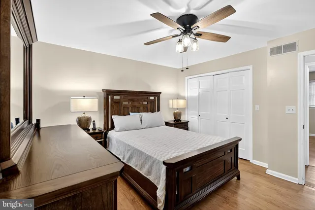 a bedroom with a bed and a flat tv screen on dresser