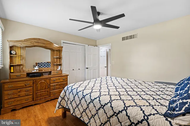 a large bed sitting in a bedroom next to a window