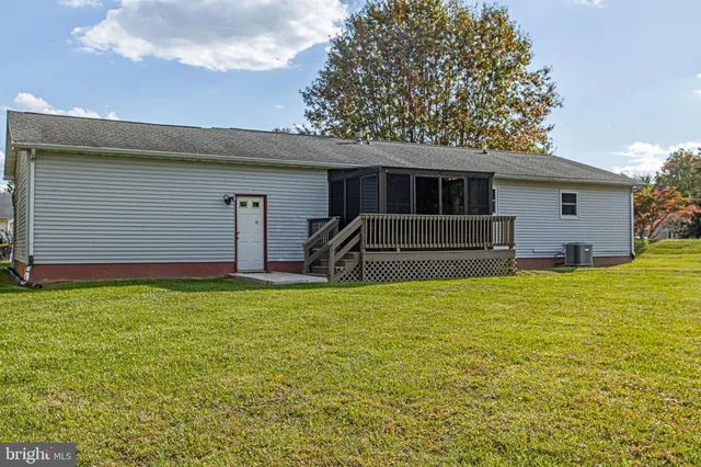 a front view of house with yard and trees