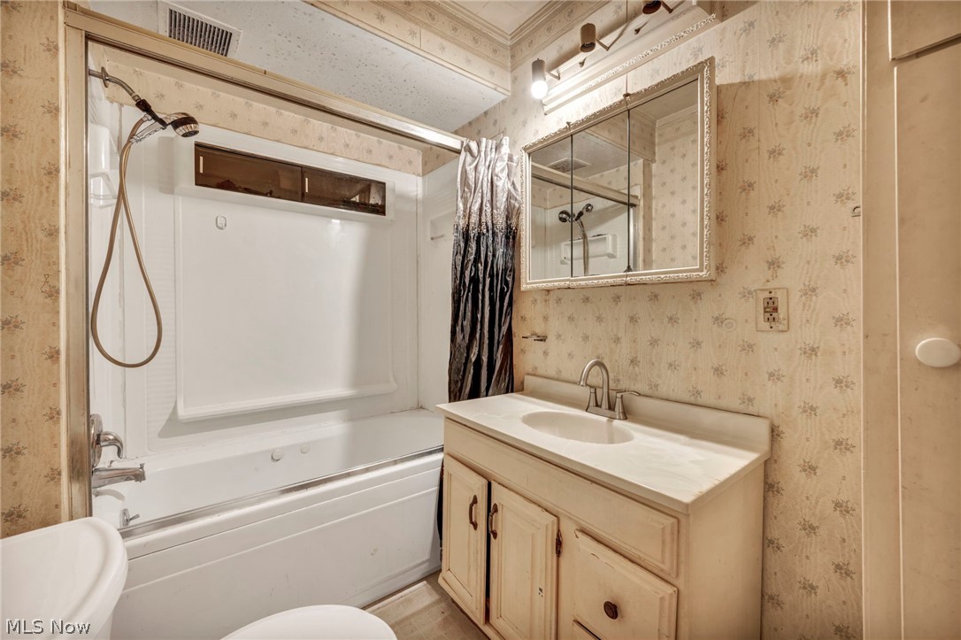 1011 Spring Road Cleveland, OH 44109 - Photo 29 of 47 Full bathroom with large vanity, toilet, and shower / bath combo with shower curtain