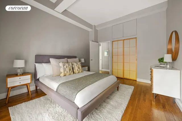 a bedroom with a bed and wooden floor