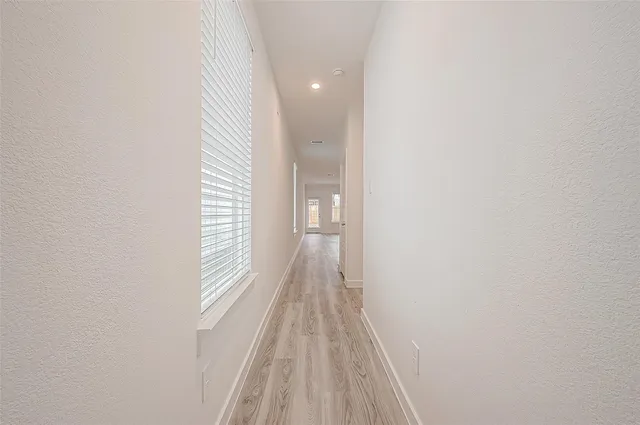 a view of a room with wooden floor