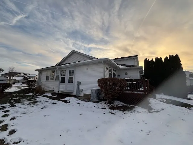 a view of a house with a yard covered in snow