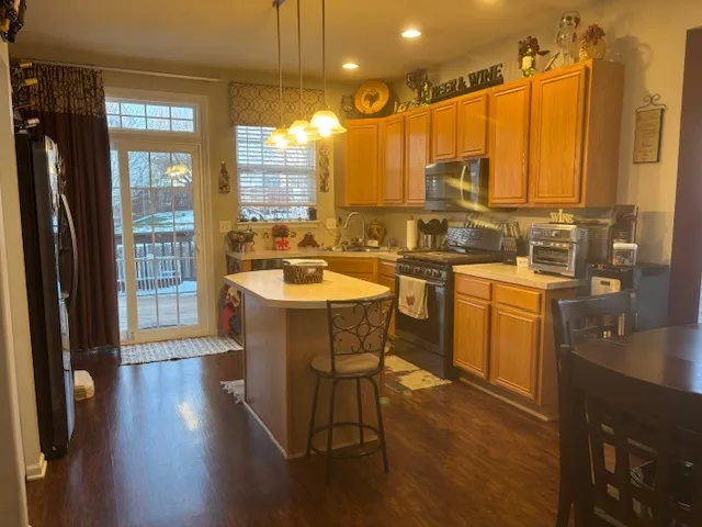 a kitchen with a sink a counter top space and stainless steel appliances
