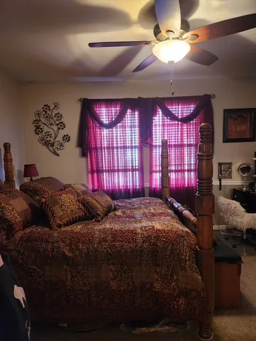 a bed sitting in a bedroom next to a window
