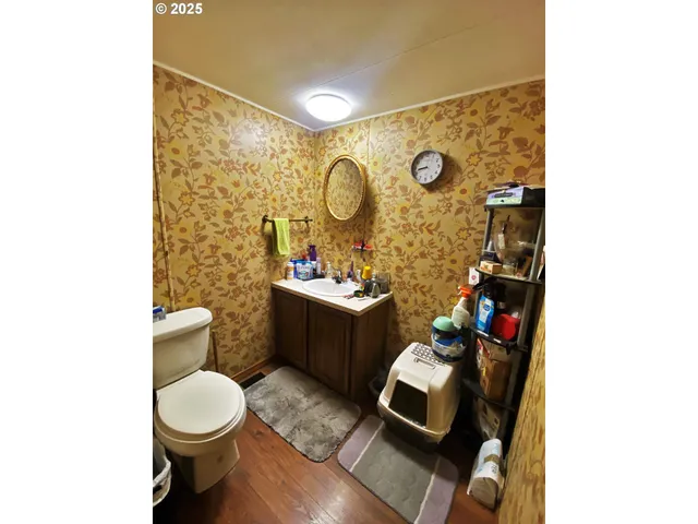 a bathroom with a toilet sink vanity tub and mirror