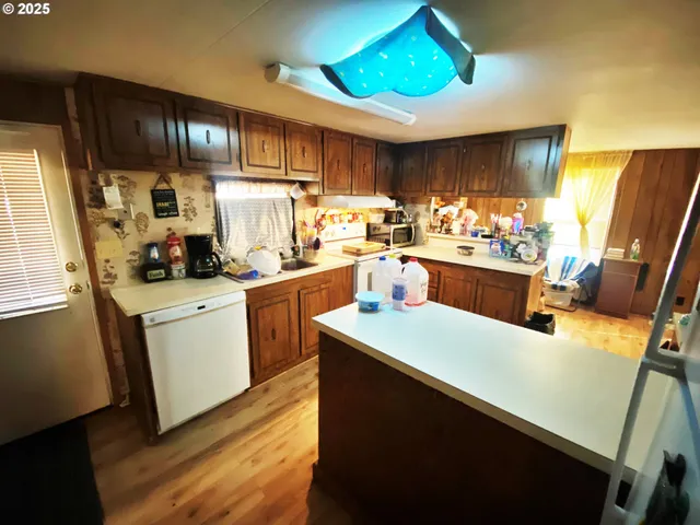 a kitchen with appliances cabinets and a counter top space