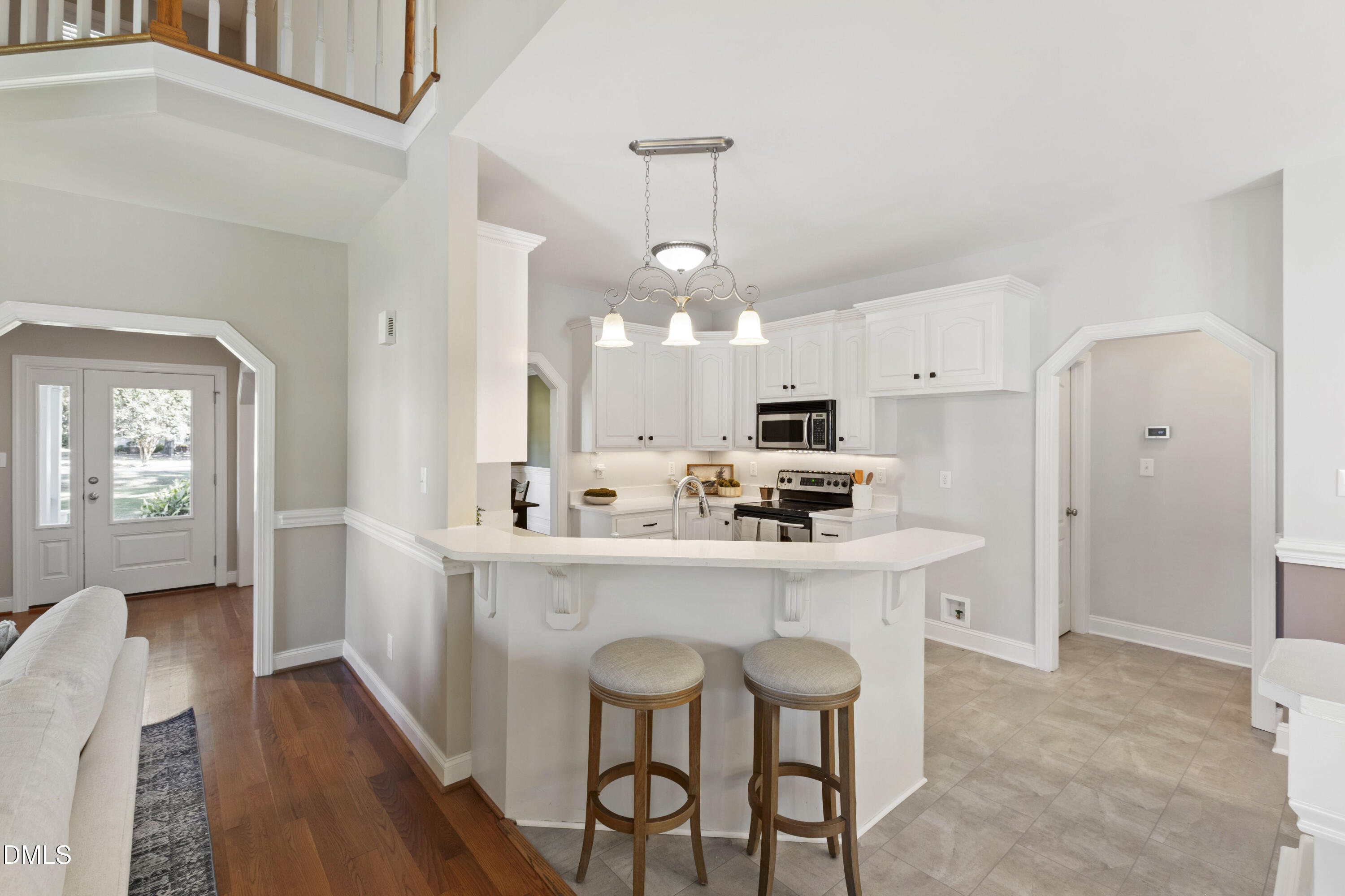 212 Fox Pen Drive Raleigh, NC 27603 - Photo 13 of 56 a kitchen with kitchen island white cabinets and stainless steel appliances
