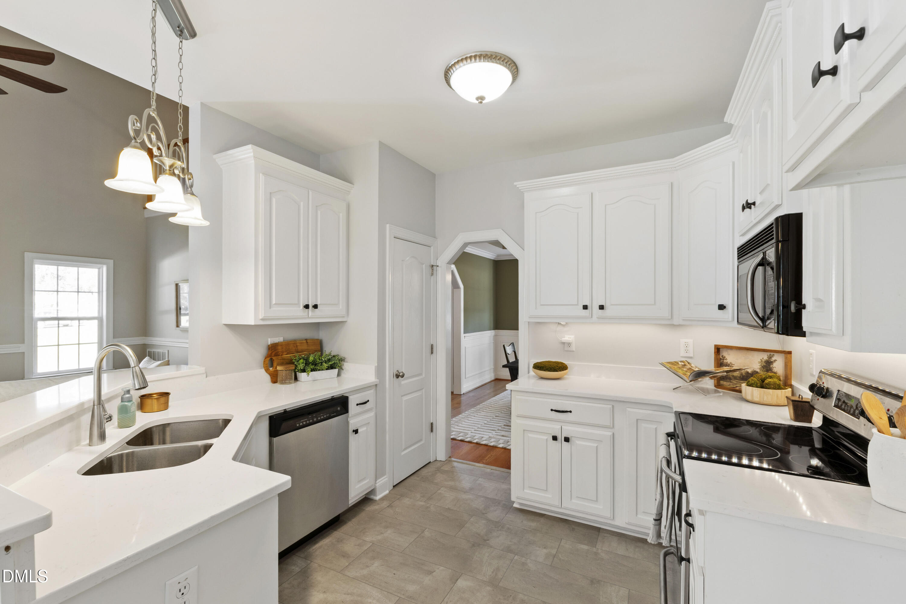 212 Fox Pen Drive Raleigh, NC 27603 - Photo 15 of 56 a kitchen that has a lot of cabinets in it and wooden floors