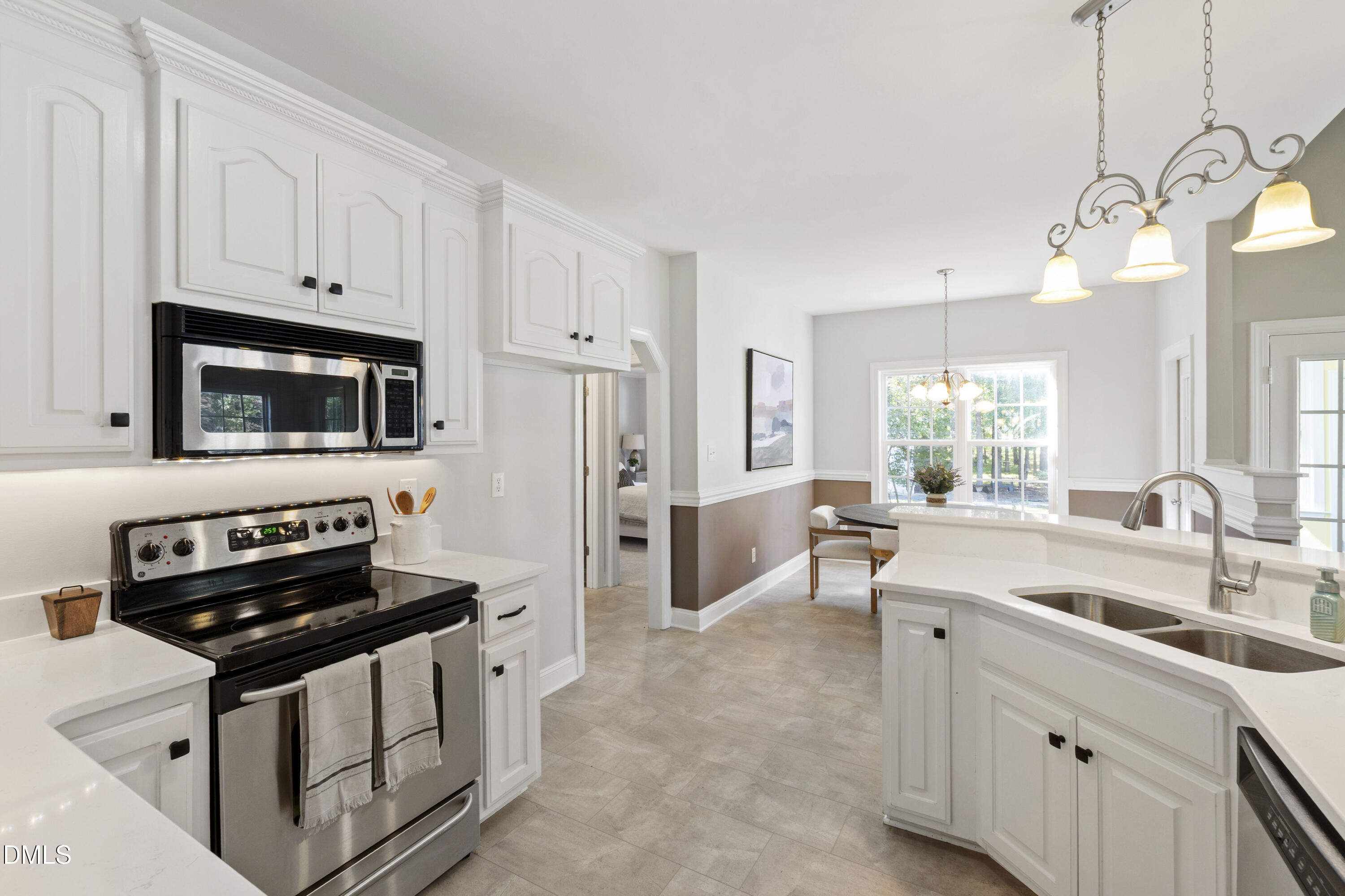 212 Fox Pen Drive Raleigh, NC 27603 - Photo 18 of 56 a kitchen with stainless steel appliances a sink a stove and a window