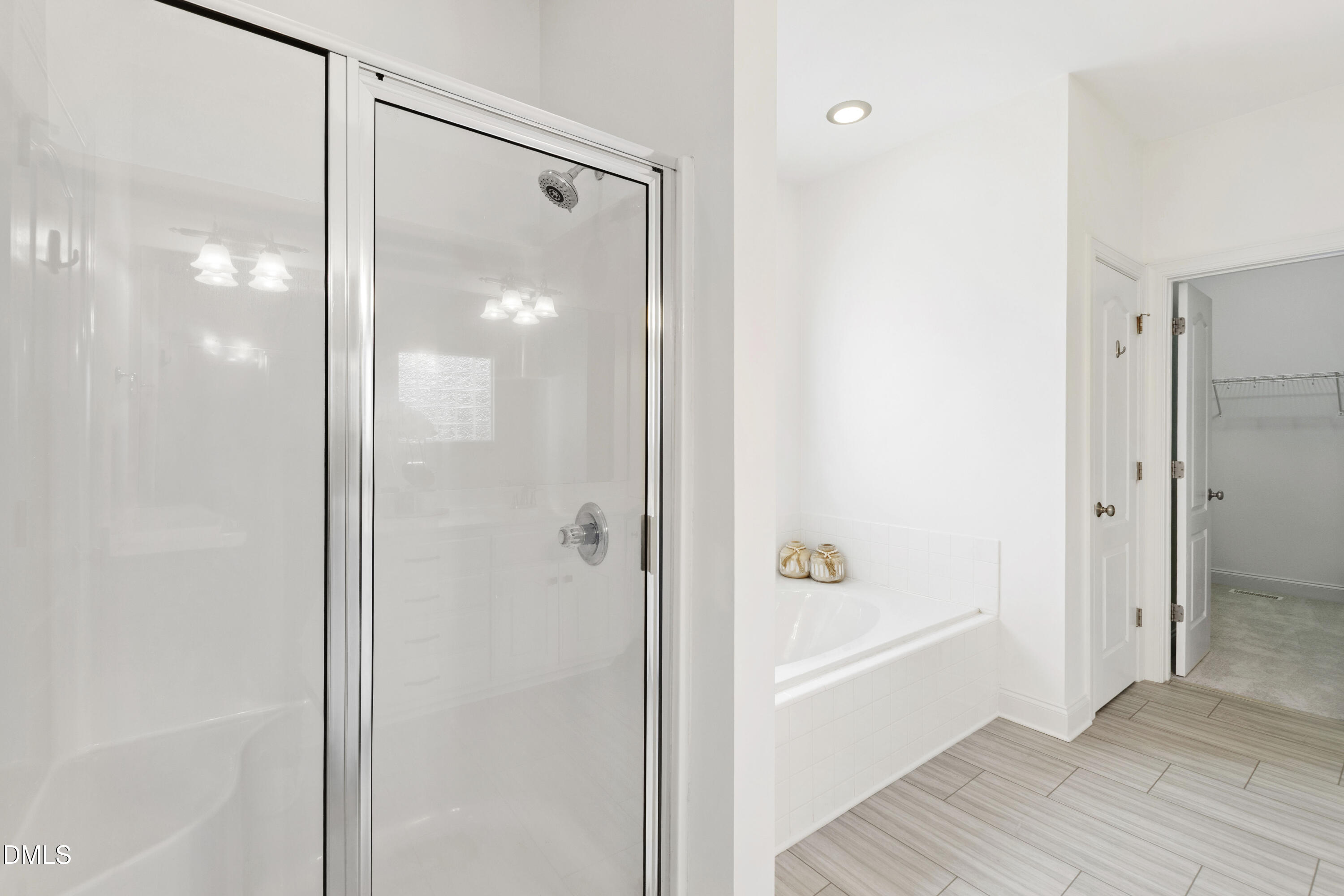 212 Fox Pen Drive Raleigh, NC 27603 - Photo 25 of 56 a bathroom with a glass shower door
