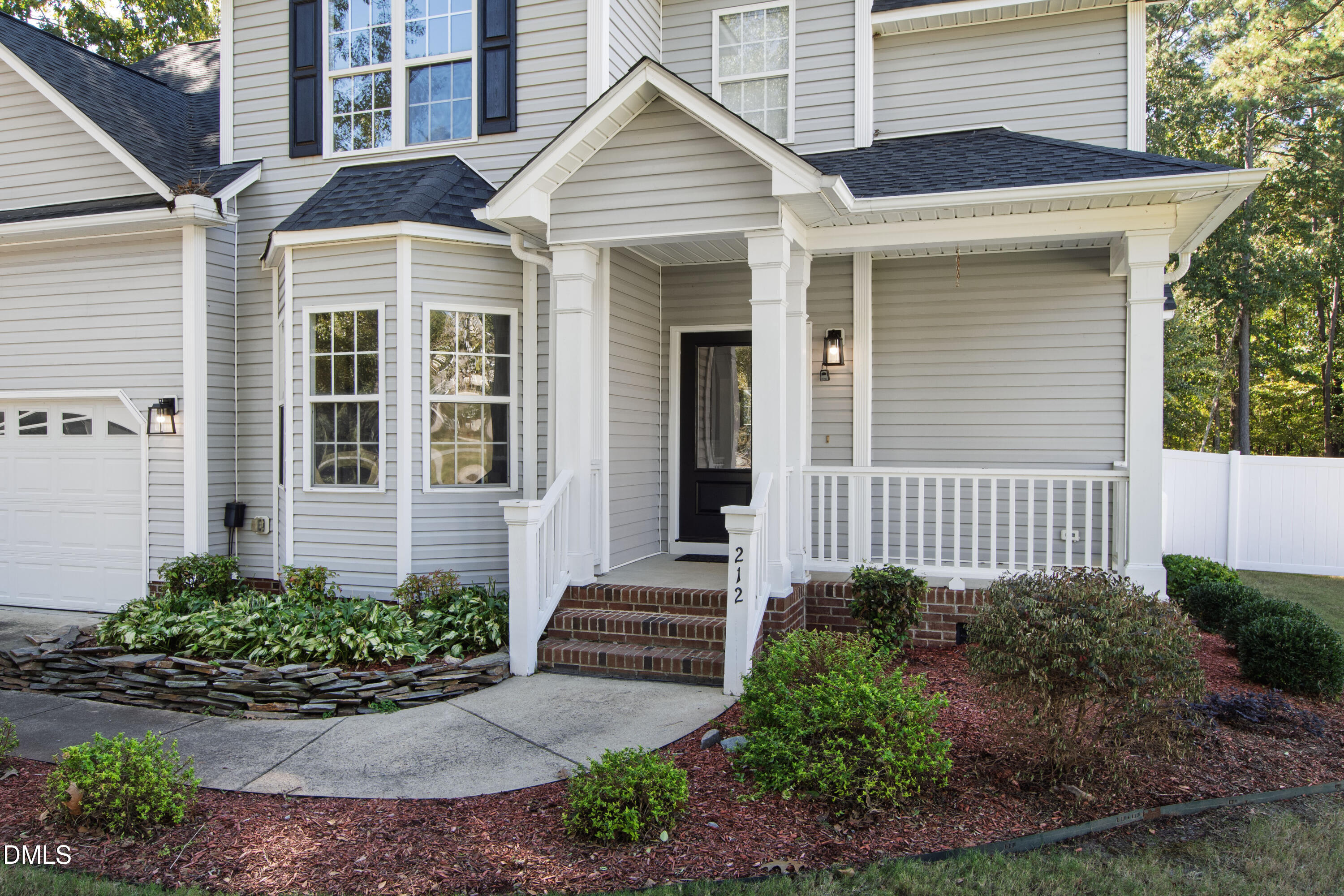 212 Fox Pen Drive Raleigh, NC 27603 - Photo 2 of 56 a front view of a house with garden