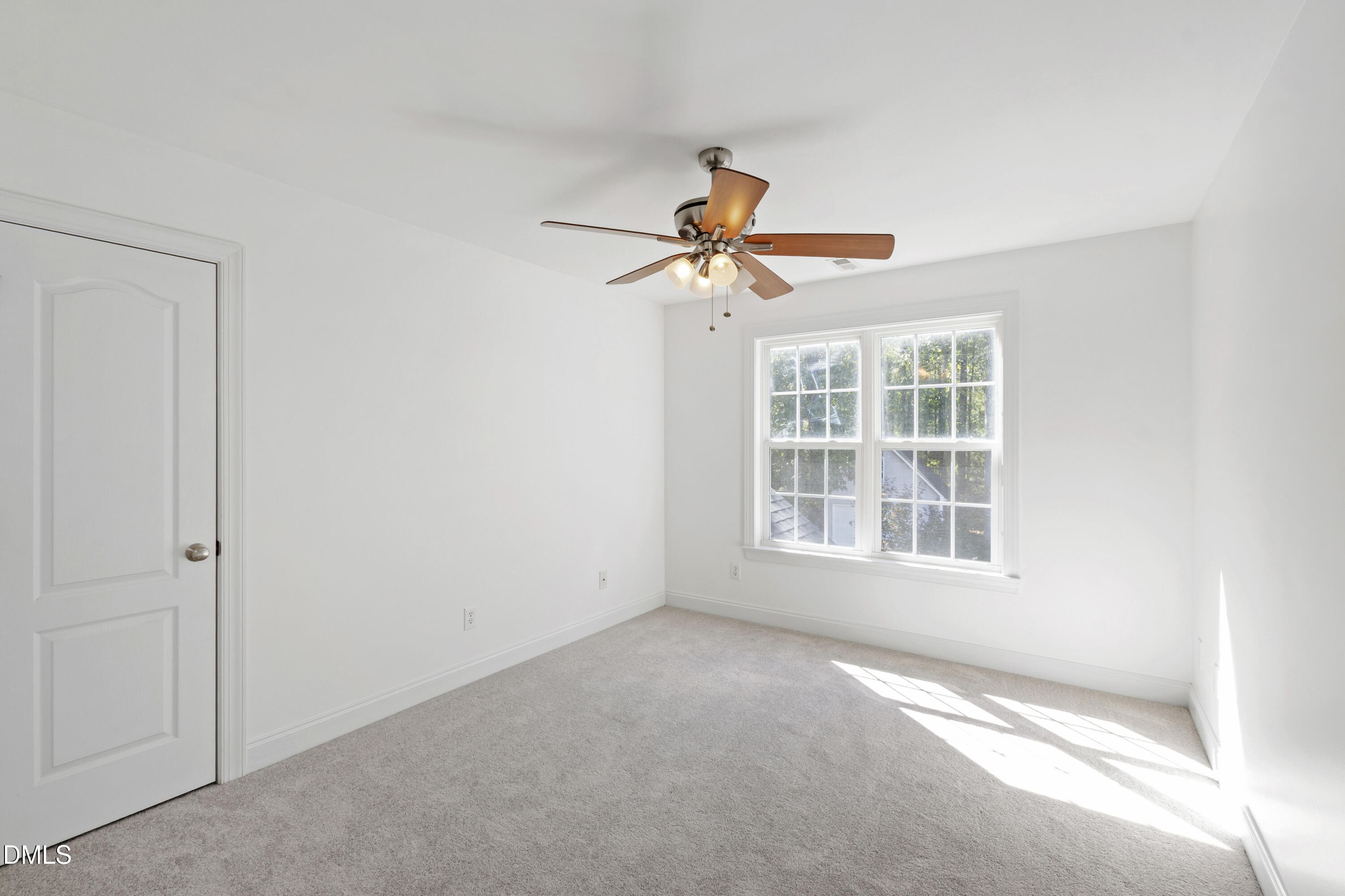 212 Fox Pen Drive Raleigh, NC 27603 - Photo 31 of 56 an empty room with a window and a fan