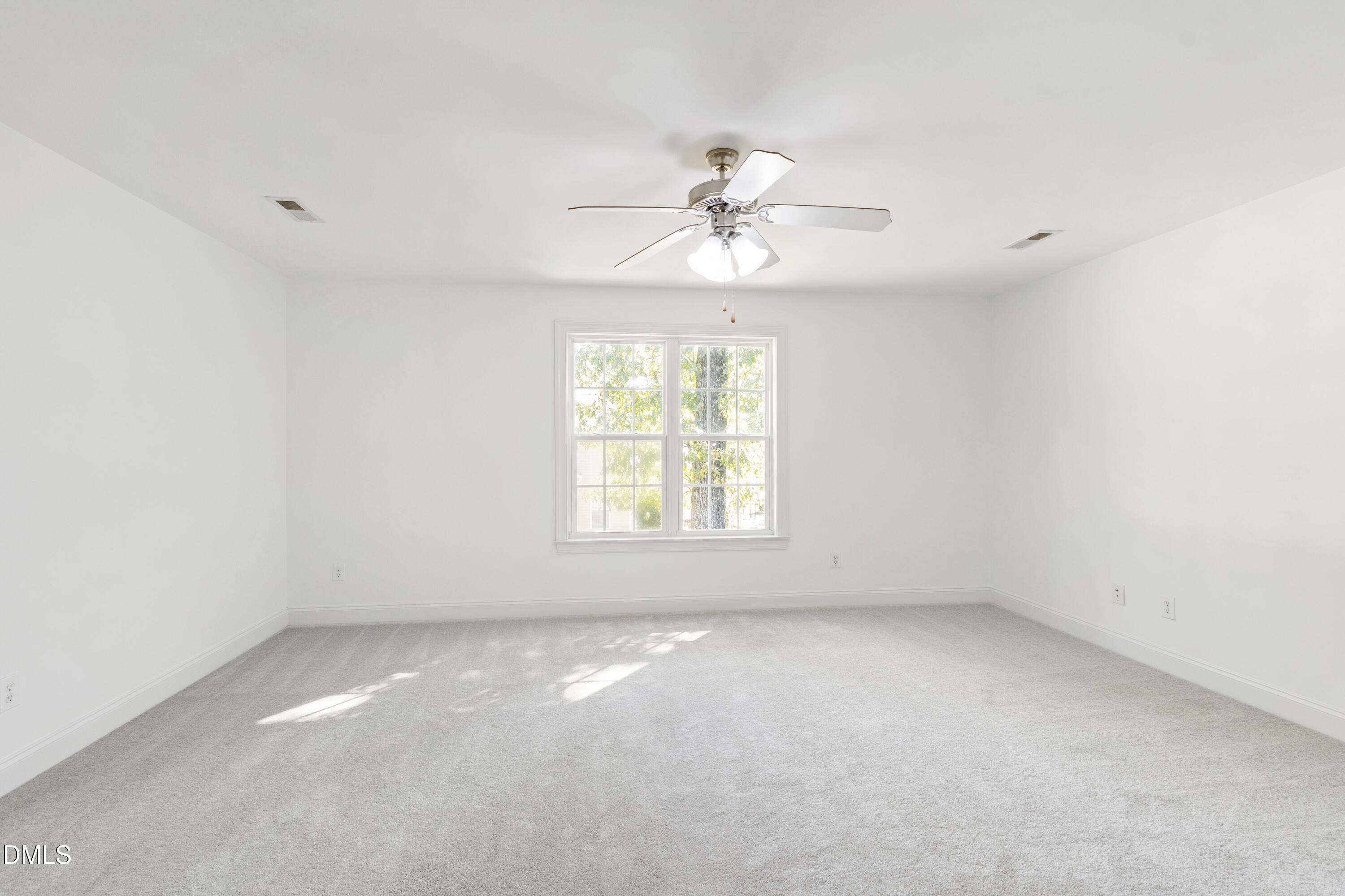 212 Fox Pen Drive Raleigh, NC 27603 - Photo 37 of 56 an empty room with a window and a ceiling fan