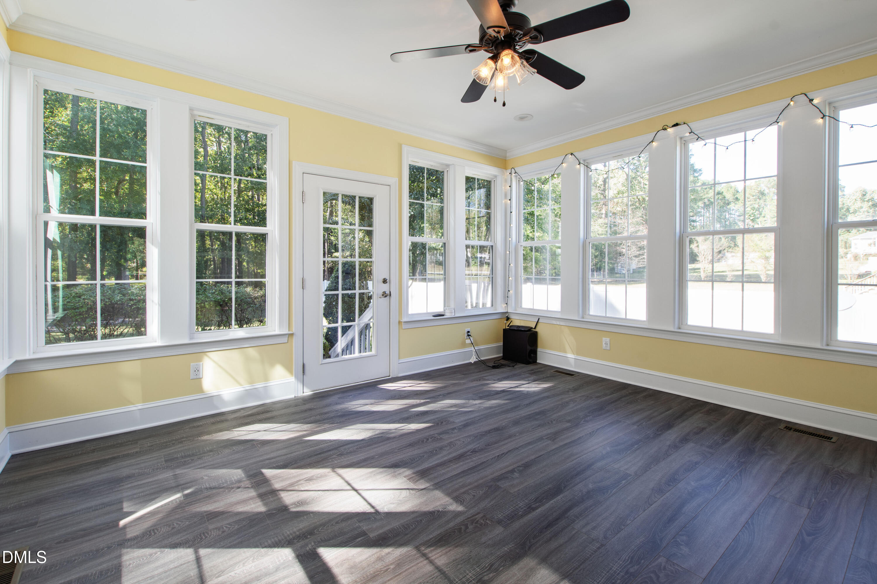 212 Fox Pen Drive Raleigh, NC 27603 - Photo 42 of 56 a view of an empty room with wooden floor and a window