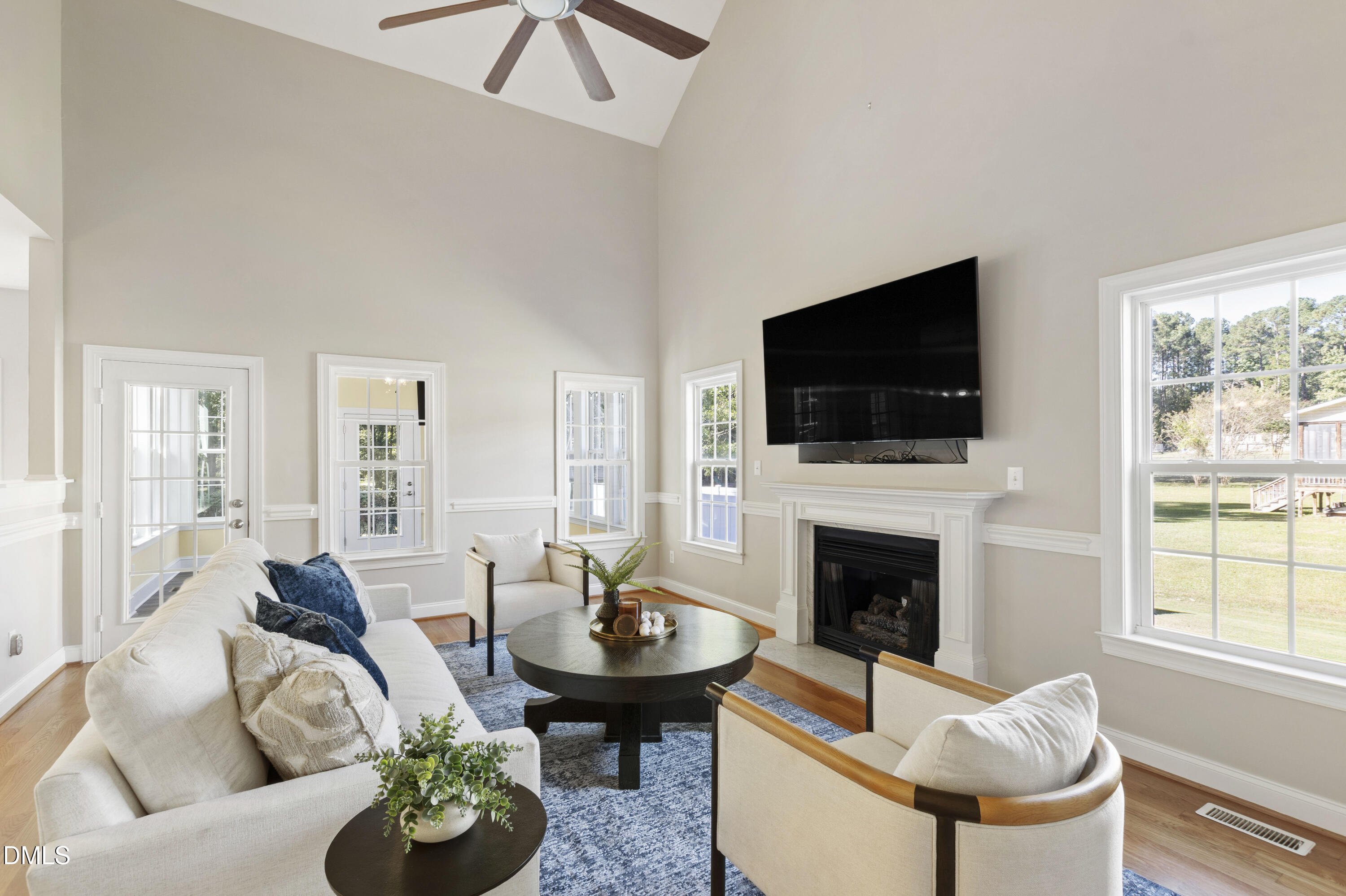 212 Fox Pen Drive Raleigh, NC 27603 - Photo 8 of 56 a living room with furniture a fireplace and a flat screen tv