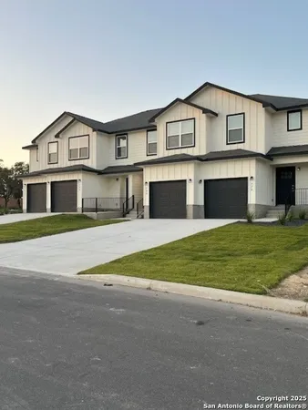 a view of house with outdoor space and parking