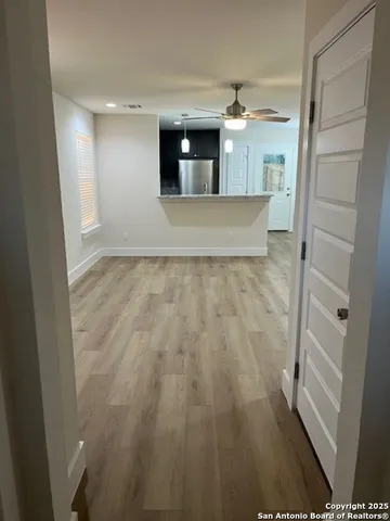 a view of a hallway to rooms