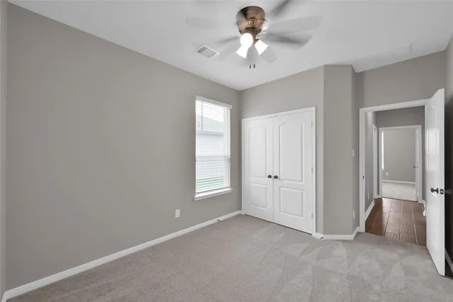 an empty room with windows and closet