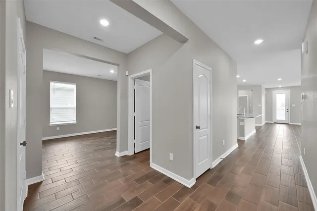 a view of a hallway with wooden floor