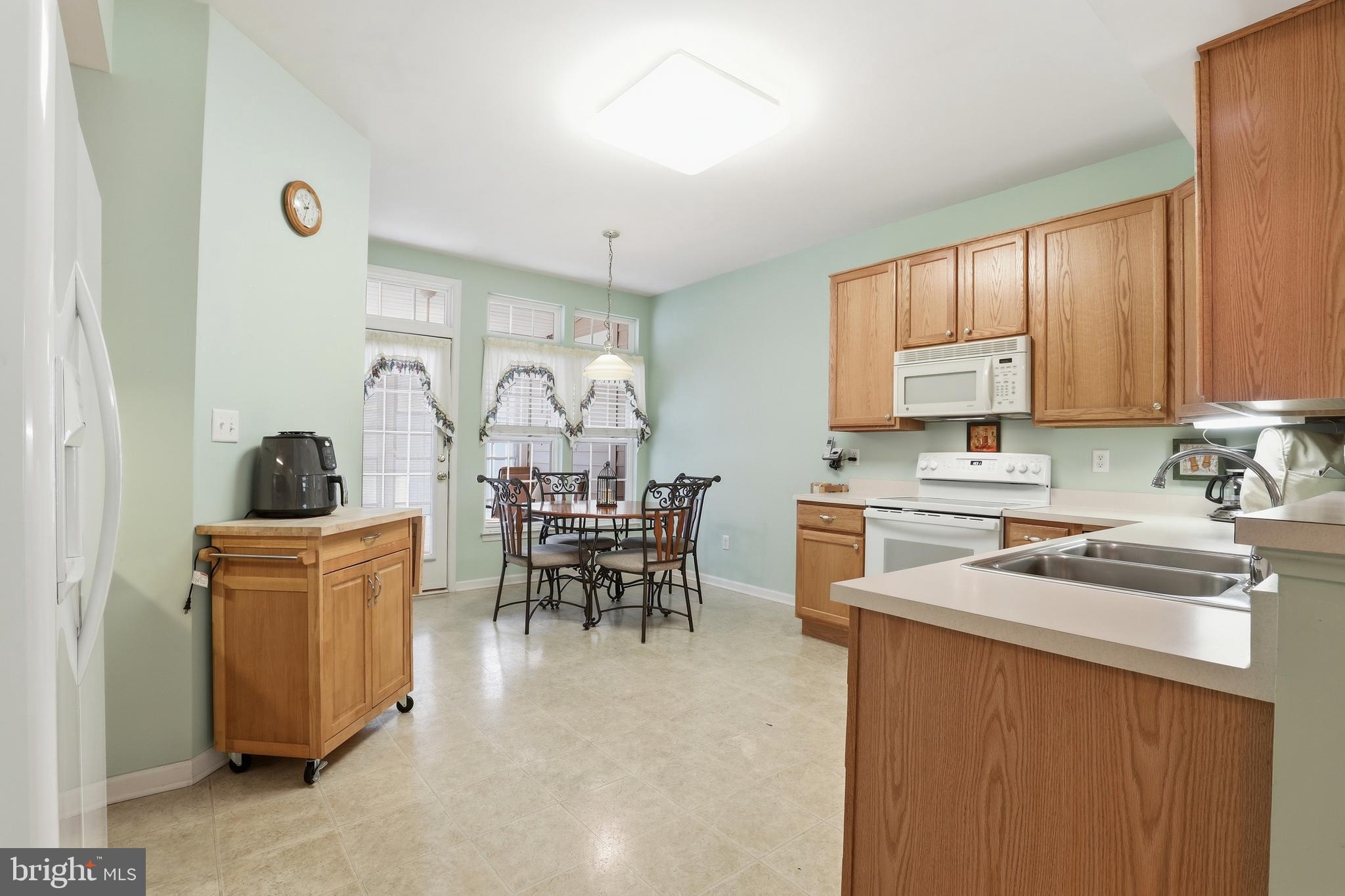 40 Brighton Street Ocean View, DE 19970 - Photo 11 of 38 a kitchen that has a lot of cabinets in it and appliances
