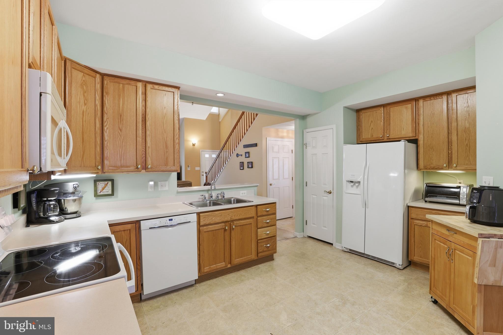 40 Brighton Street Ocean View, DE 19970 - Photo 12 of 38 a kitchen with a sink stove and refrigerator