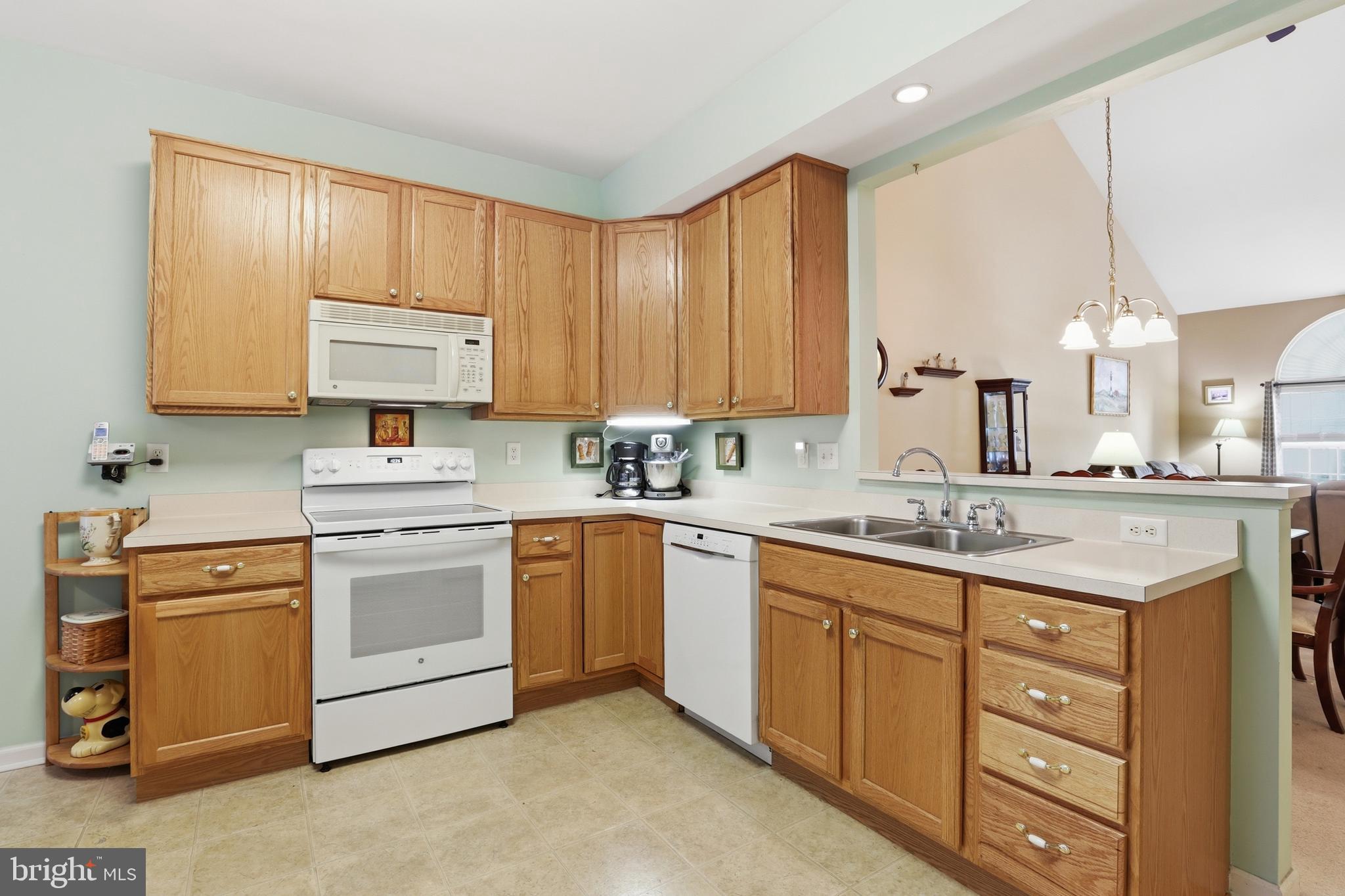40 Brighton Street Ocean View, DE 19970 - Photo 14 of 38 a kitchen with stainless steel appliances granite countertop a sink stove and cabinets