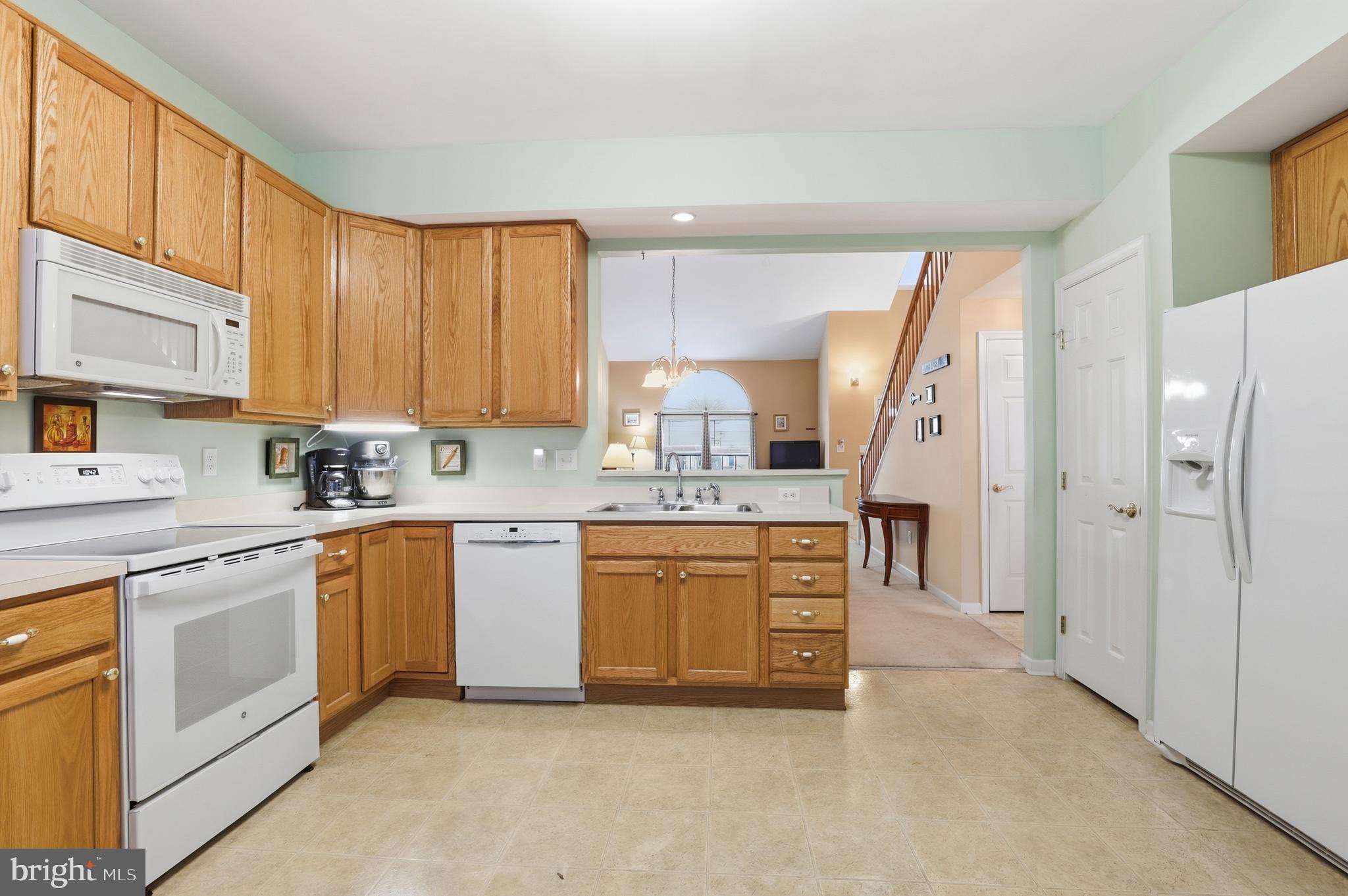 40 Brighton Street Ocean View, DE 19970 - Photo 16 of 38 a kitchen with stainless steel appliances granite countertop a stove a sink and a refrigerator