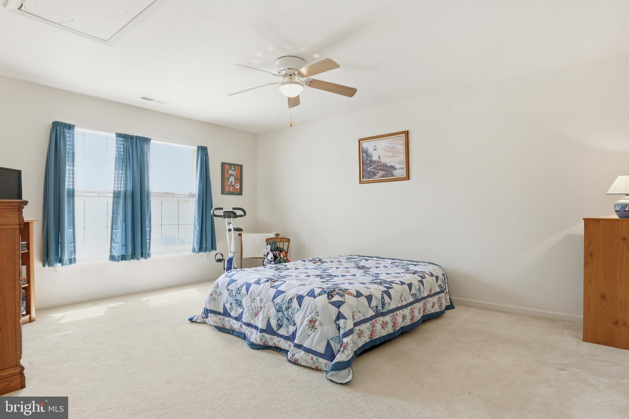 40 Brighton Street Ocean View, DE 19970 - Photo 25 of 38 a bedroom with a bed and a chandelier